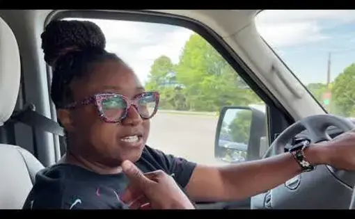 a woman sits in car