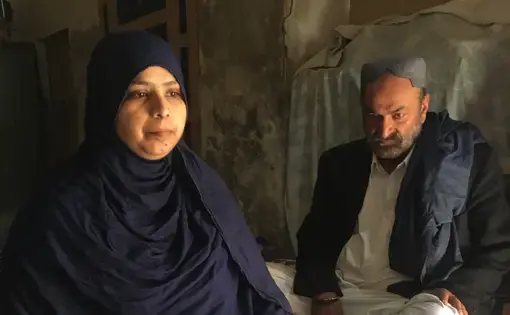 Husband and wife sit together in Pakistan