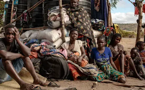 Families displaced by conflict wait at a full resettlement area near Montepuez, Cabo Delgado