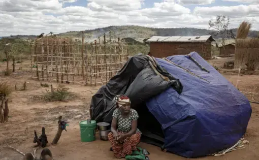 woman sits in front of tent