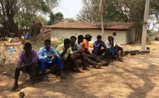 Photo of men sitting in village