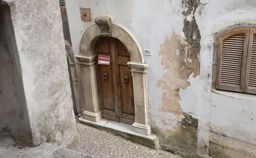 for sale sign on ancient door