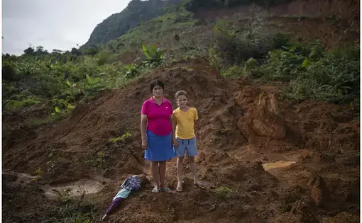 two girls stand on a roof