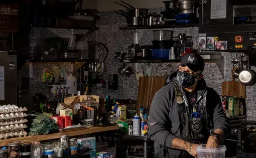 A masked chef in his kitchen