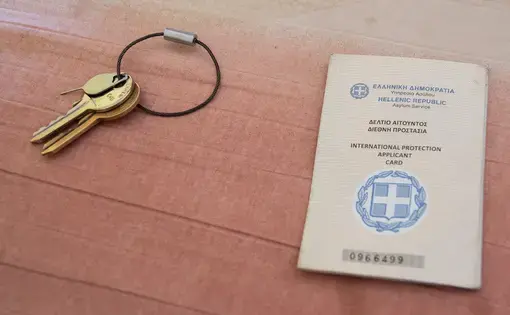 A card given to migrants when they've applied for asylum and a pair of keys