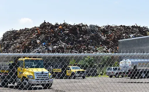 photo of truck in front of trash plant