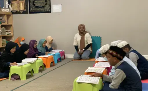 Rohingya children and their teacher in a classroom