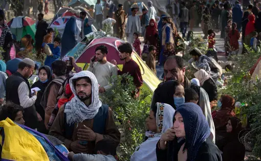 Displaced Afghans arrive at a makeshift camp from the northern provinces