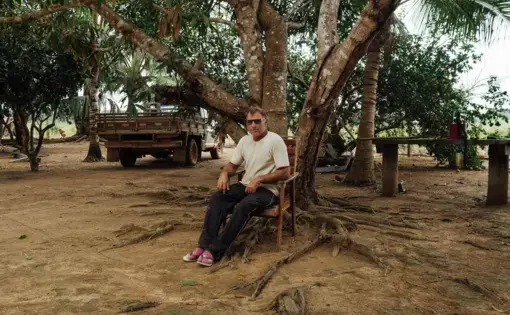Man sitting against tree