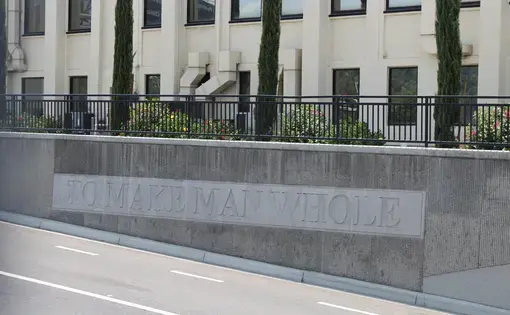 Sign reads "to make man whole"