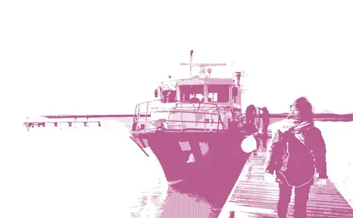a woman walks along a pier next to a docked boat