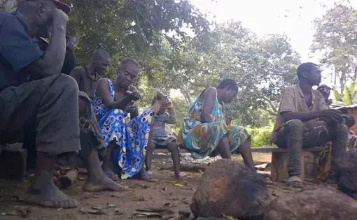 Four people are sitting and talking to each other.