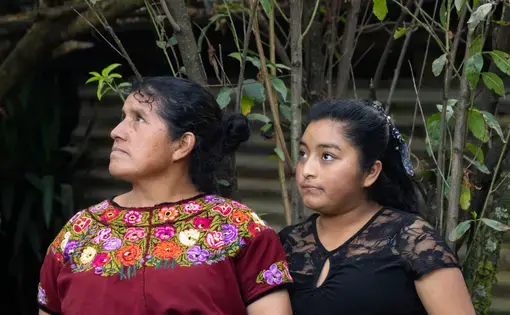 Maria stands with daughter