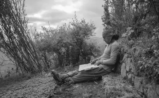 Man writes against mountain