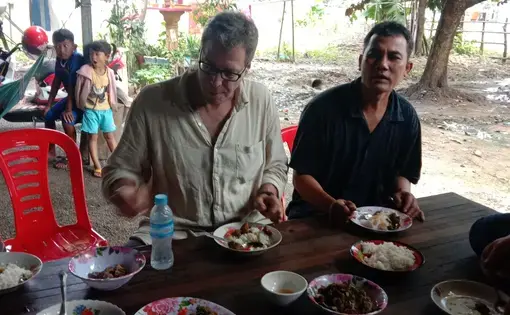 Michael Scott Moore eating with one of the men