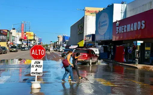People walking through sewage water
