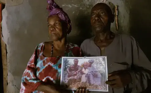 Family members hold photo of son