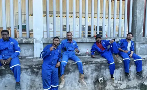 Workers sit outside factory
