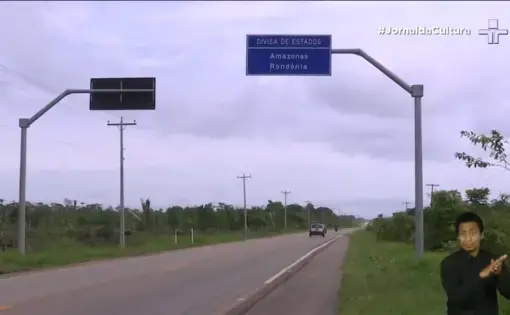 An aerial shot of two road signs and a highway in Brazil.