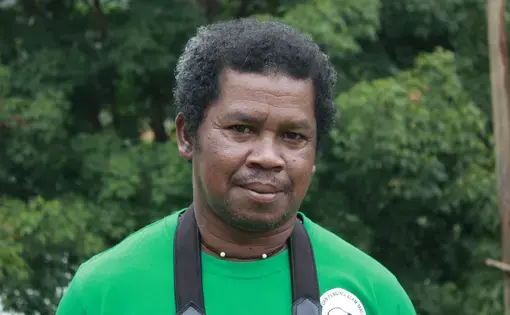 Image of a person wearing a green shirt with a tapir logo.