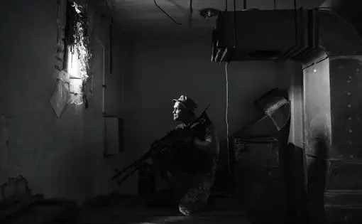 Man holds gun in room