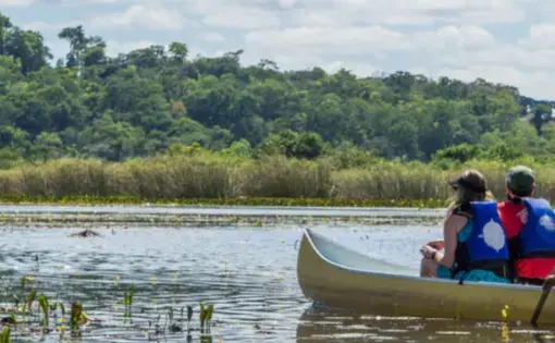Two people are paddling a canoe on the river.