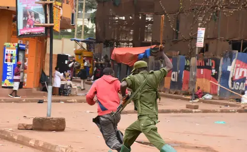 A man getting hit by soilder