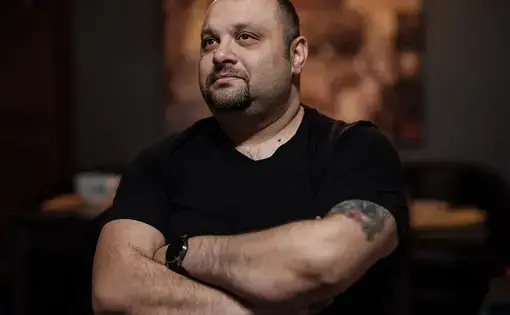 Man with arms crossed.