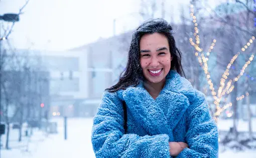 Alice Qannik Glenn pictured in a blue furry coat in the snow