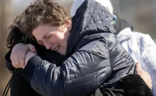 Two people embrace