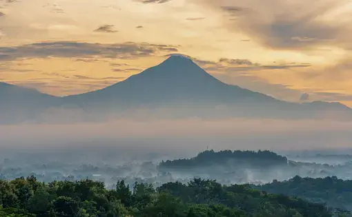 An aerial view of a mountain range in mist.