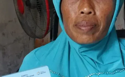 a woman shows her government ID card