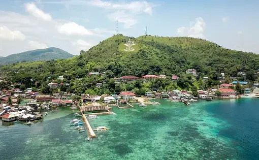 An aerial overview of a beach resort and its lush blue waters in the Philippines.
