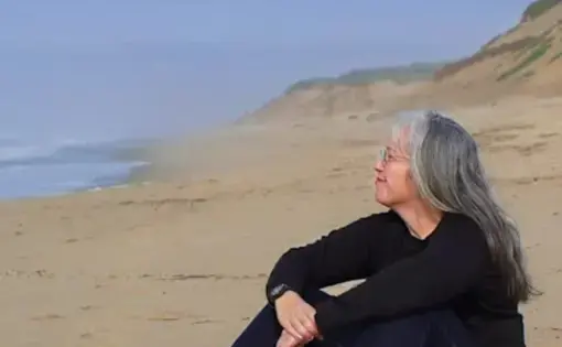 Lynn sits at the beach