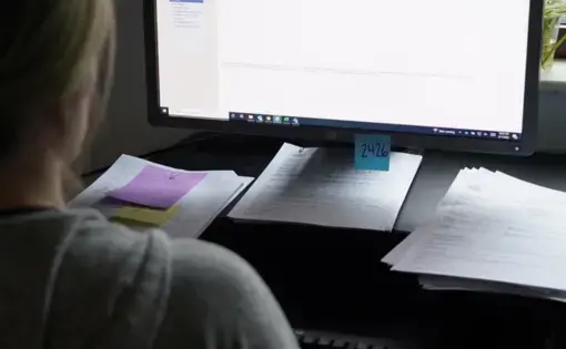 a social worker sits at their computer desk