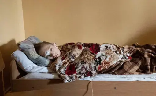 an injured child lays in a bed