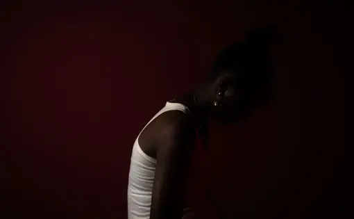 person shrouded in shadows