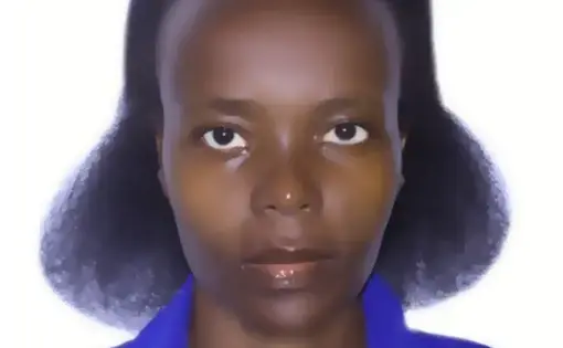A woman with brown hair wears a purple shirt.
