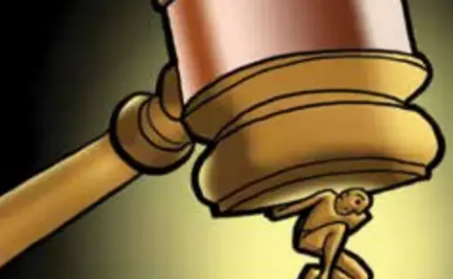 a human figure is crushed under a gavel