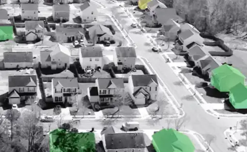 a photo in black and white with houses owned by corporations in color