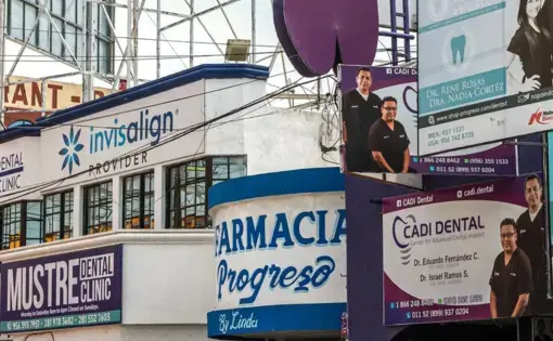 a pharmacy surrounded by dental clinics and billboards