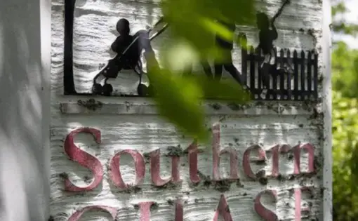 a neighborhood entrance sign is surrounded by greenery and says "Southern Chase"