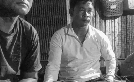 two men sit for a meal