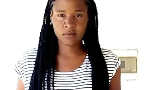 A woman with black hair and a striped black and white shirt.