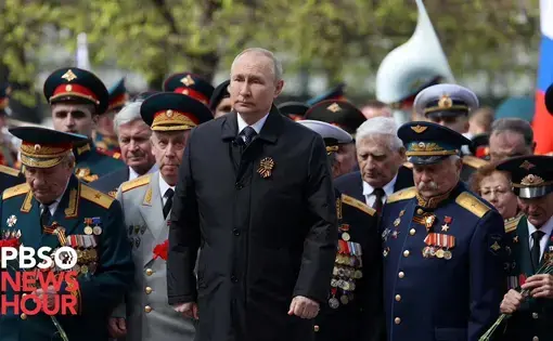 Russian president Vladimir Putin walks in a Victory Day parade