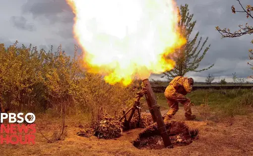 a soldier takes cover as a Javelin anti-tank weapon fires