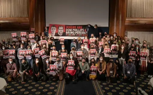 Pulitzer Center staff members, grantees, and Fellows hold "Where are Dom Phillips &amp; Bruno Pereira?" posters at the Center's annual conference, Interconnected: Reporting the Climate Crisis.