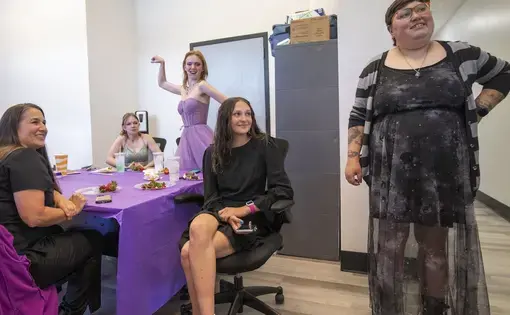 four women sit at a decorated table