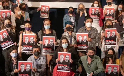 a group photo of rainforest based journalists holding "where are Dom and Bruno?" posters