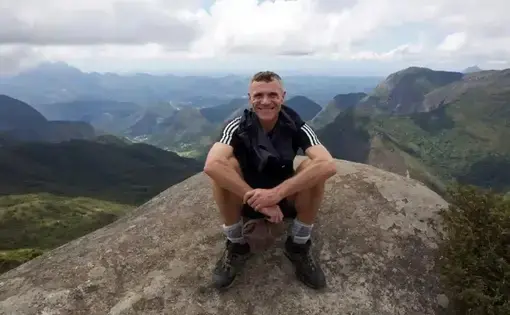 Photo of Dom Phillips smiling on a mountainside